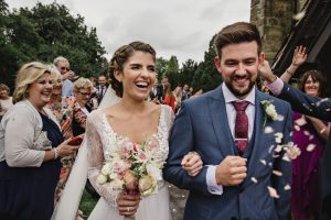 bride and groom on confetti run
